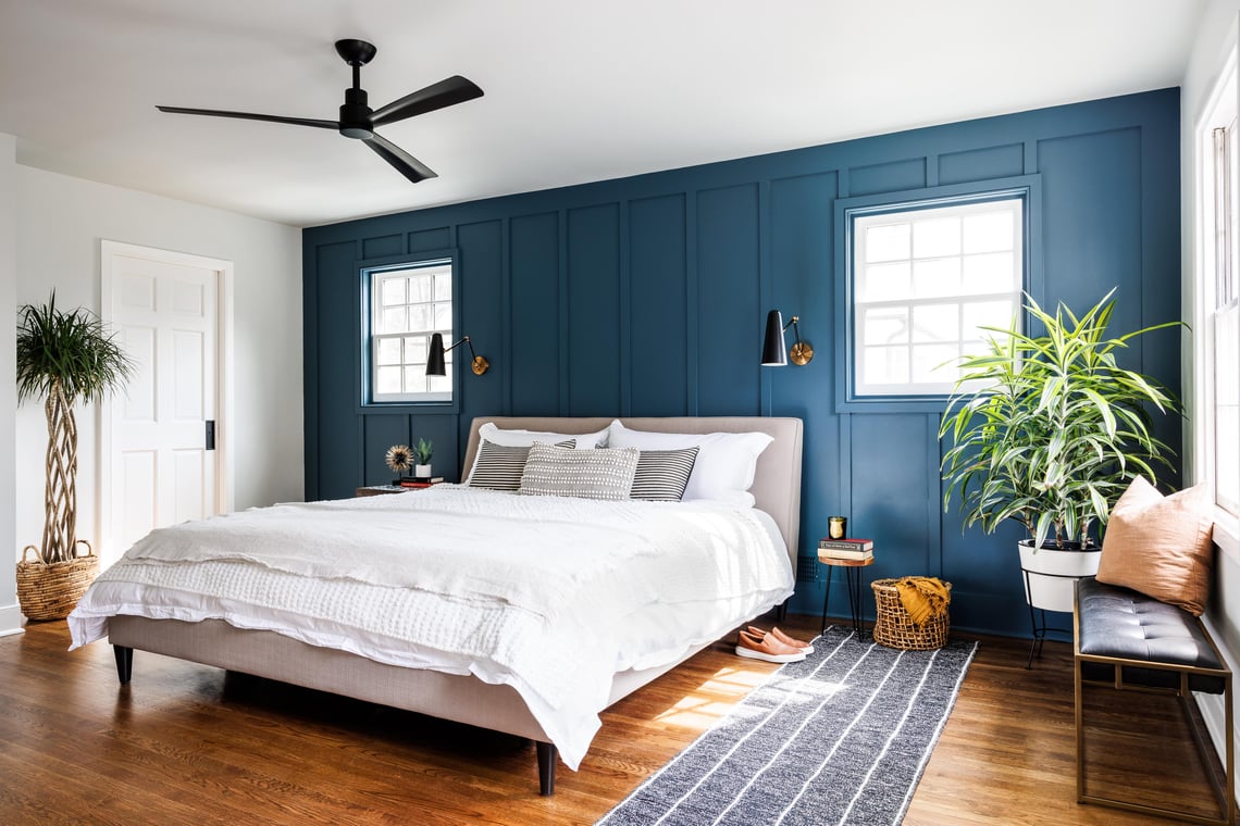 Four Brothers primary bedroom renovation in Alexandria, VA, with a blue paneled accent wall and symmetrical windows.