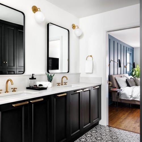 Four Brothers primary bathroom renovation in Alexandria, VA, with black cabinetry, brass fixtures, and patterned floor tile.