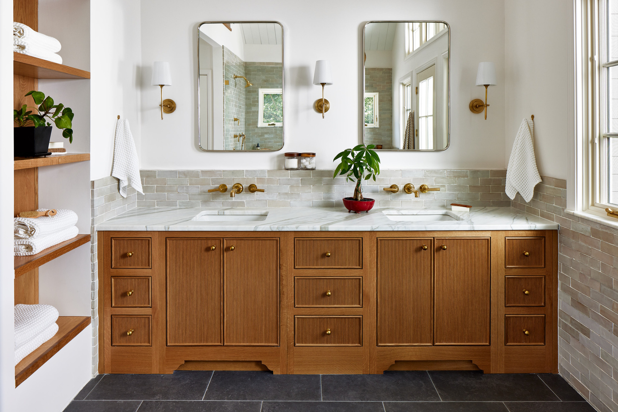 luxury bathroom renovation with custom double sink vanity with marble countertops.
