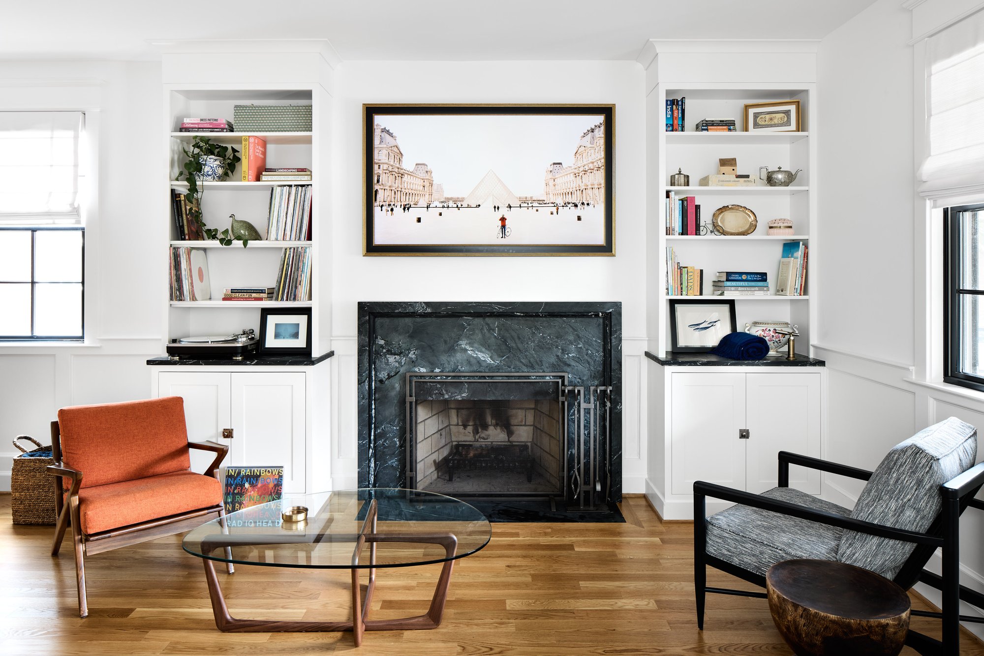 Four Brothers living room renovation in Del Ray, Alexandria, with a black marble fireplace and custom built-in shelving.