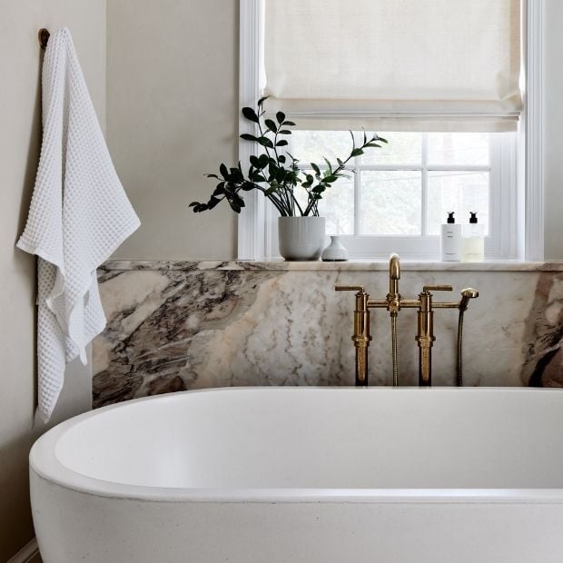 free standing bath tub in front of window in a master bathroom in bethesda md (1)